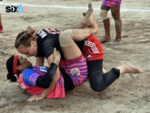 women kabaddi players playing kabaddi game with each other