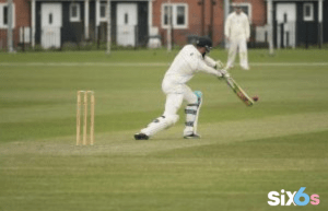 player betting in the Asia Cup ground with a bat and wicket placed behind him